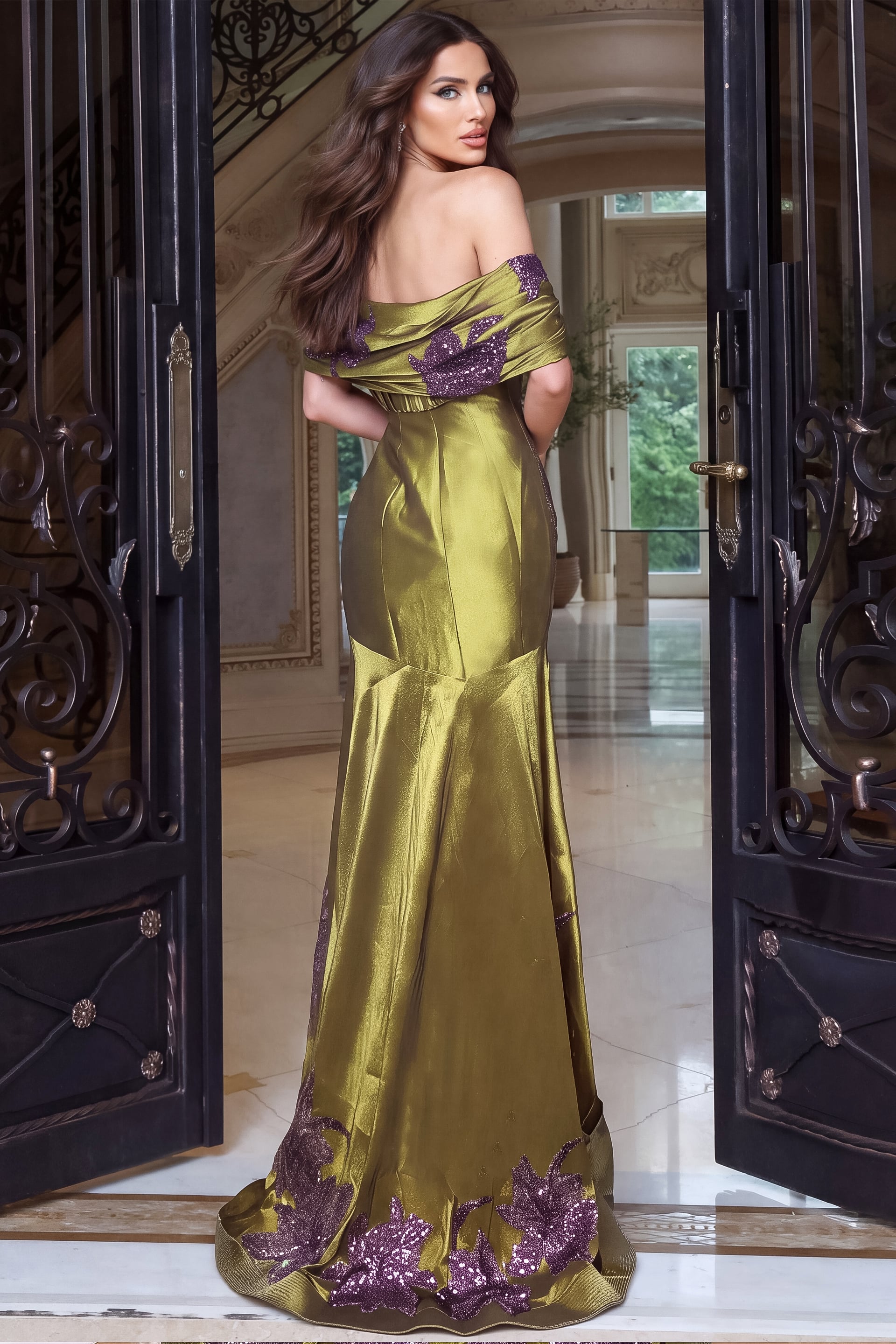 Turned to show the back of an olive satin mermaid gown with draped shoulder band and sequin hem