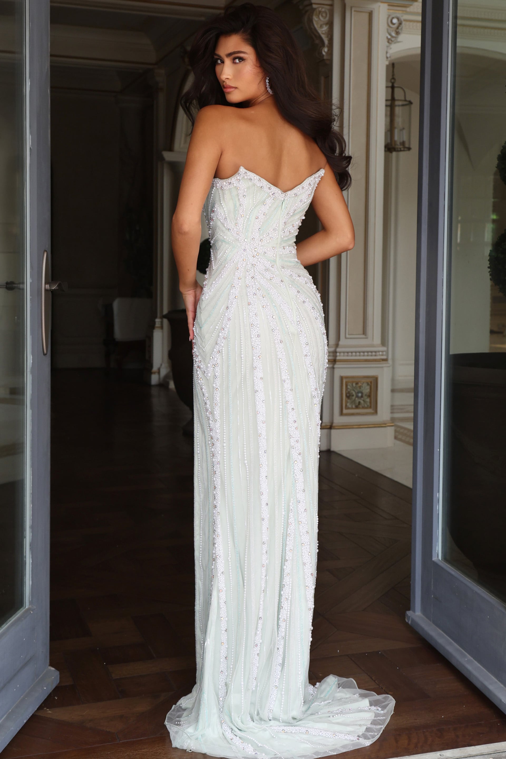 back view of mint beaded column gown with covered strapless back and sheer tulle train 54075