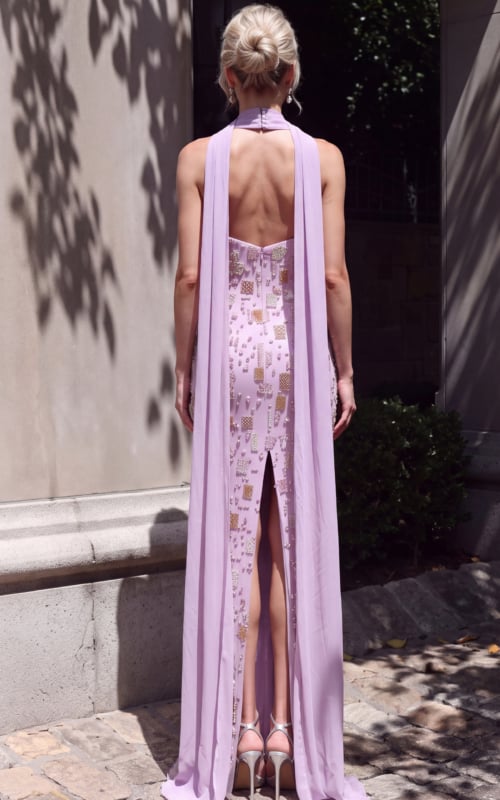 Back view of lilac gown featuring long sheer cape panels