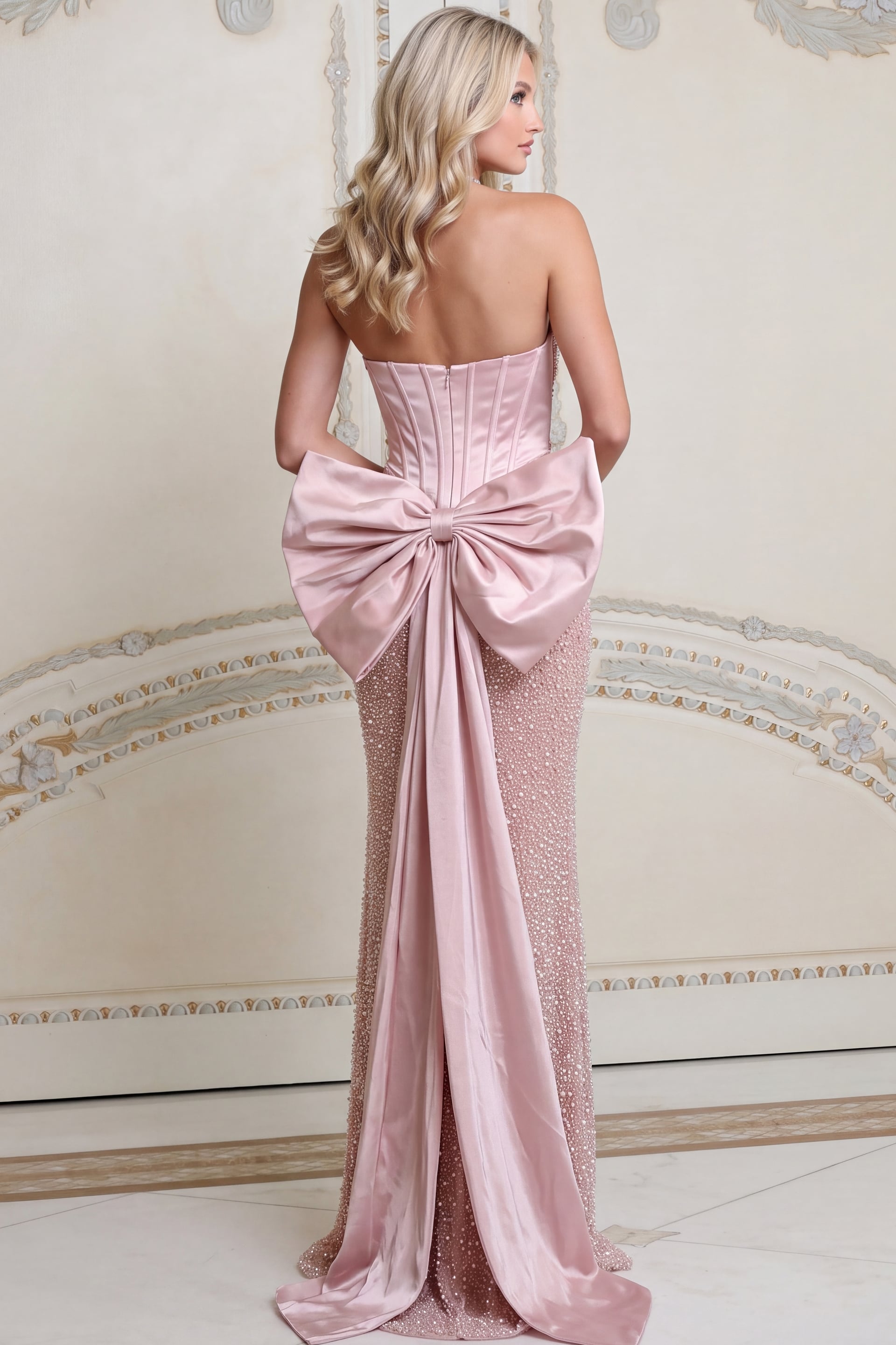 Back view of blush beaded trumpet gown showing corset back and large bow