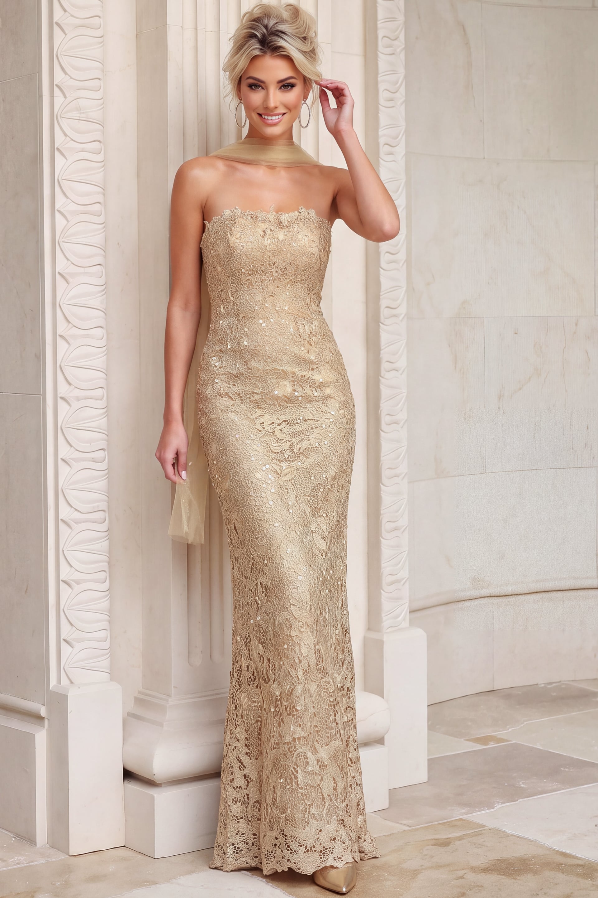 Fitted lace gown in warm gold, strapless with a sheer stole resting behind the neck