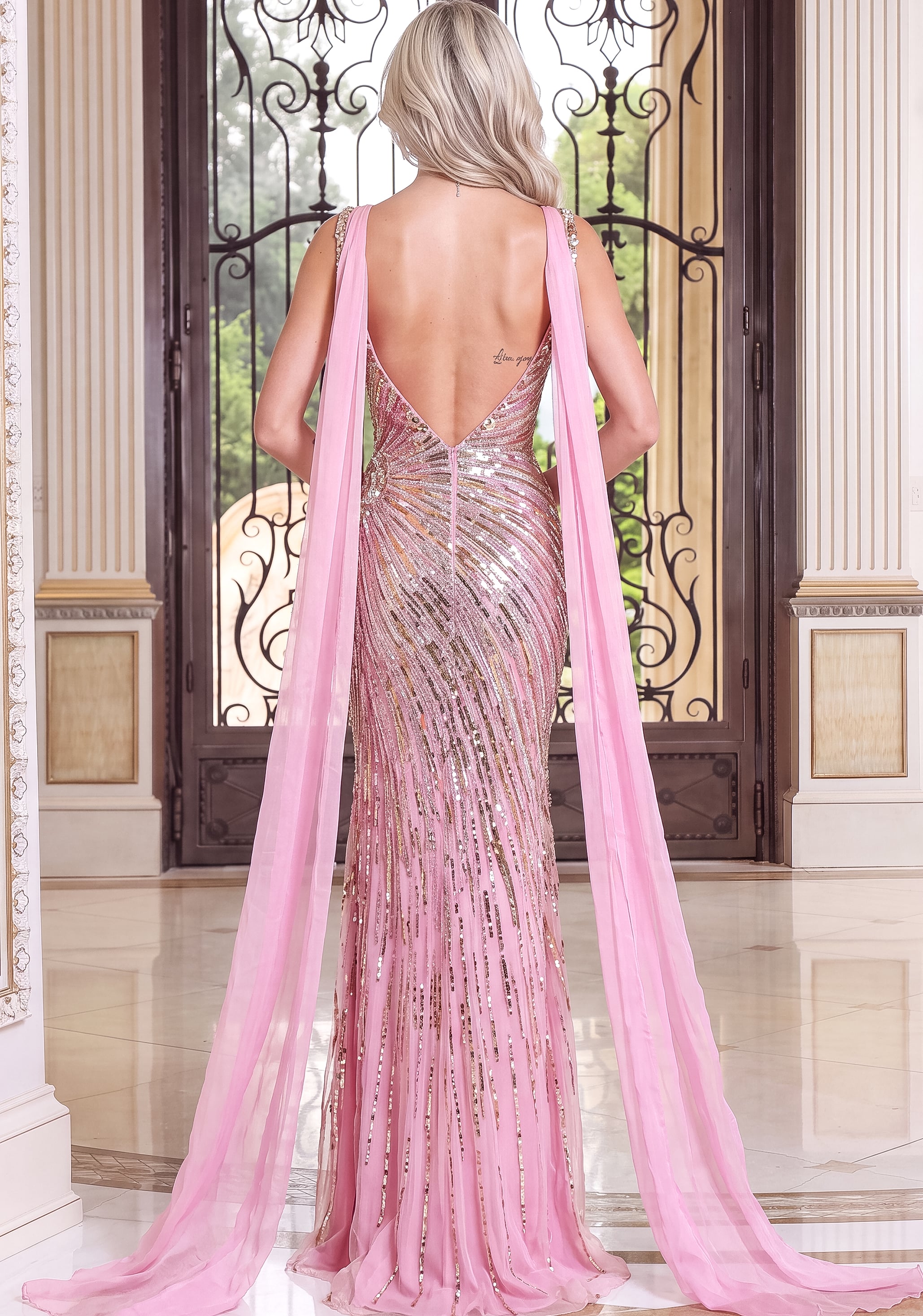 back view of pink beaded v neck sheath gown with high slit and attached cape