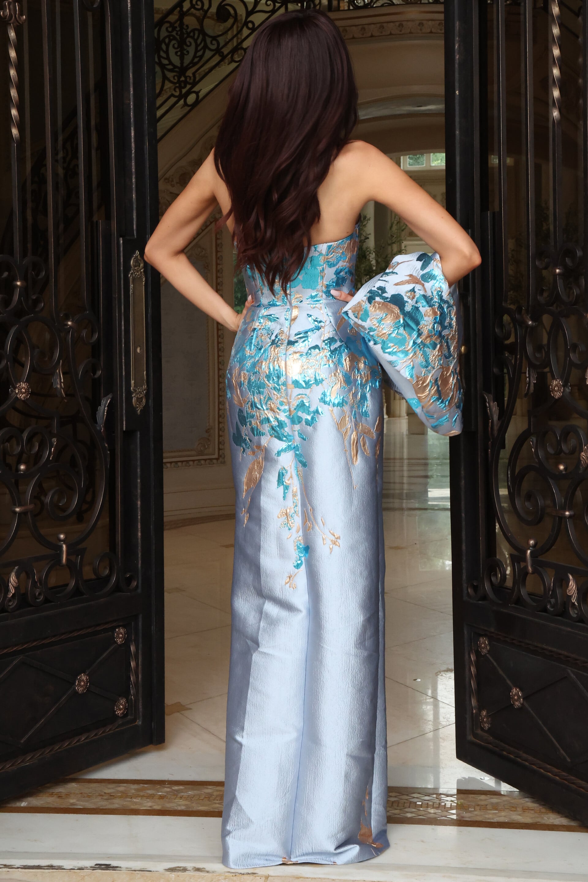 Light blue satin gown with abstract watercolor print and backless design, back view