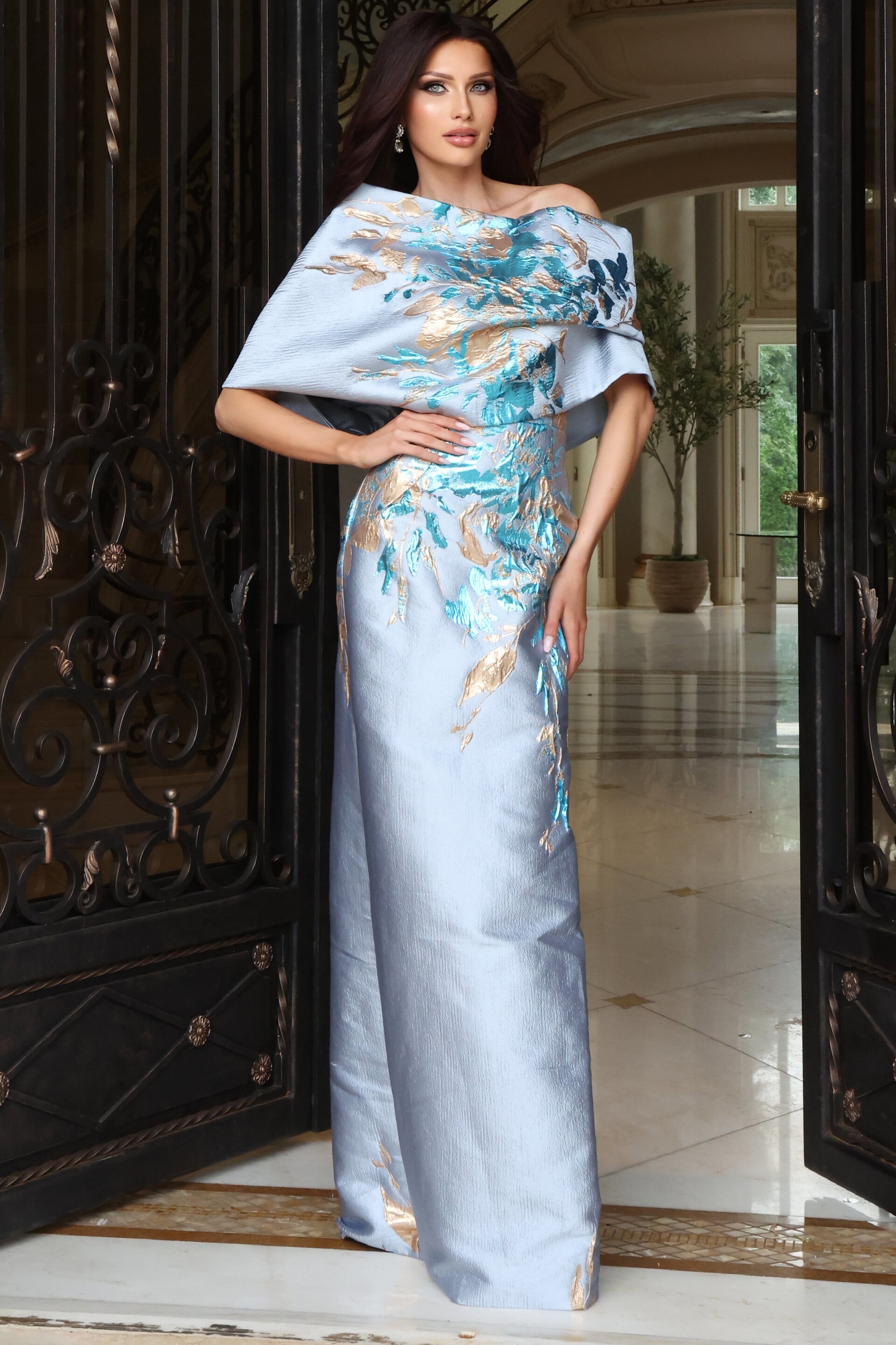Light blue satin gown with abstract watercolor print and off-the-shoulder draped neckline, front view