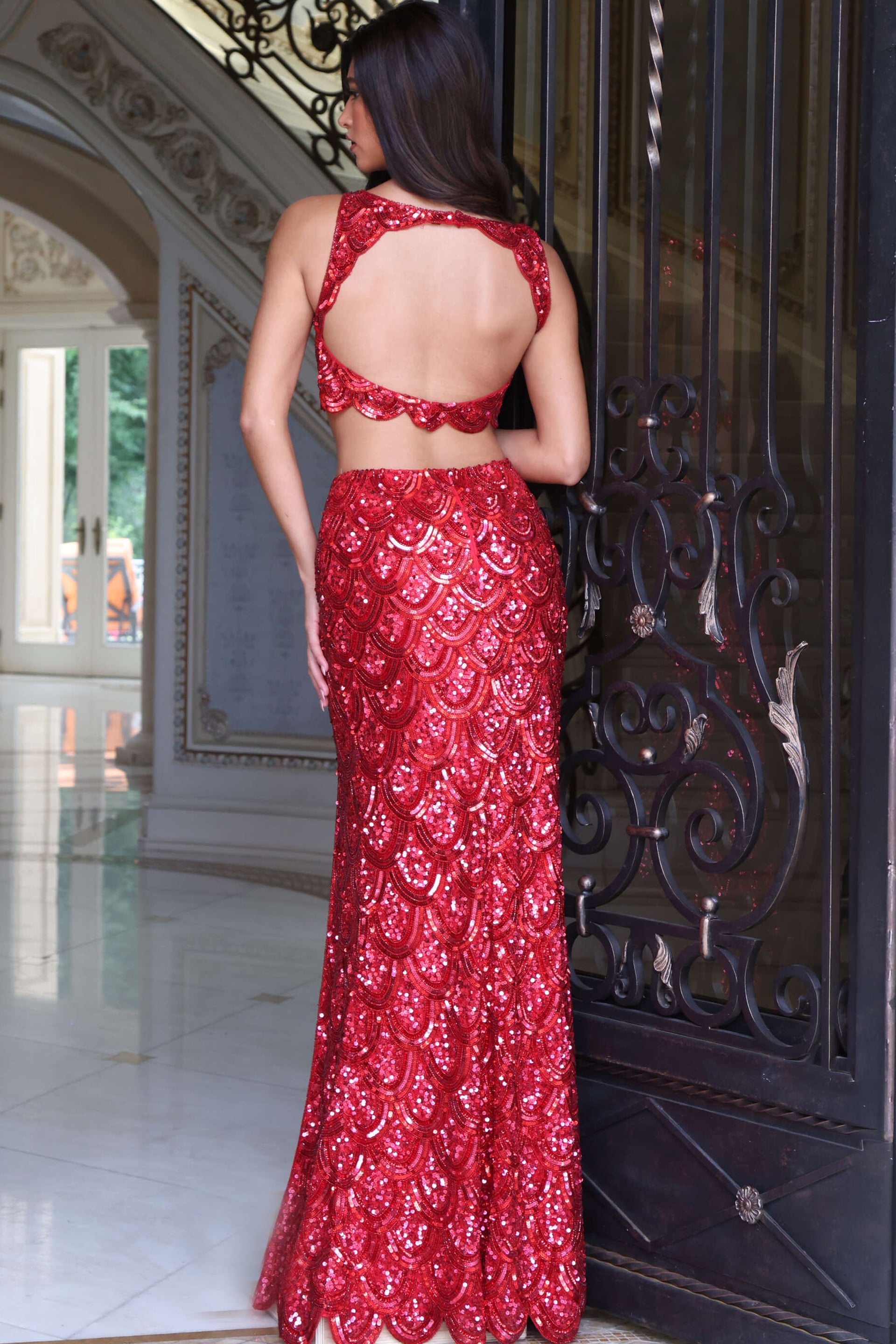 keyhole open back view of red scalloped sequin two piece gown