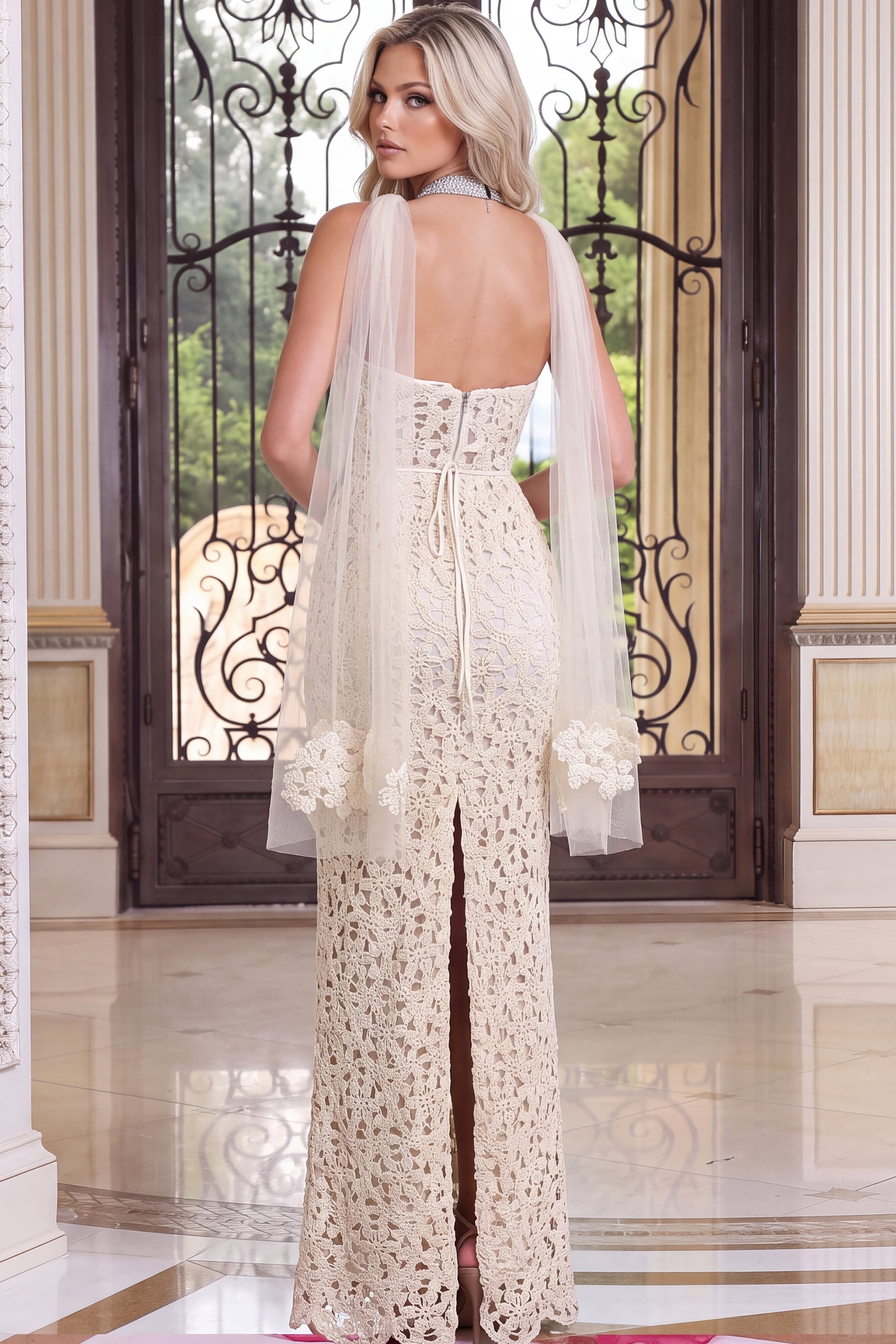 Back view of ivory crochet gown with flowing sheer sleeves