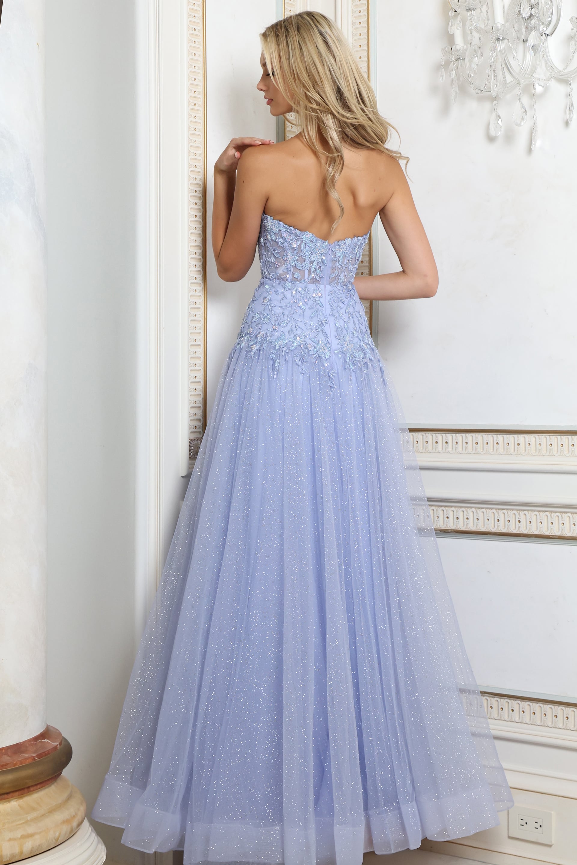 Back view of periwinkle tulle gown showing corset back and full glitter tulle skirt