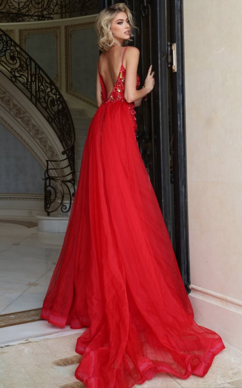 Back view of red beaded gown showing low open back and flowing tulle overskirt train