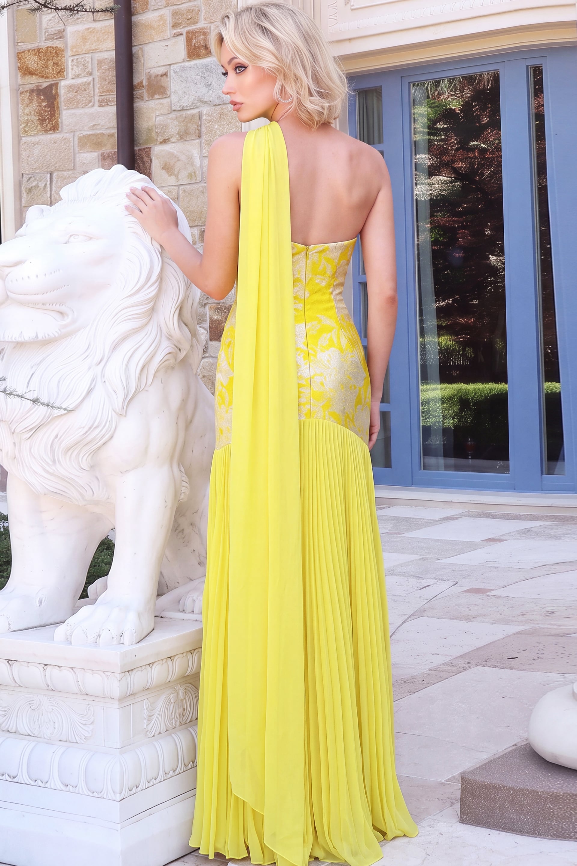 Bright yellow evening dress with flowing scarf detail