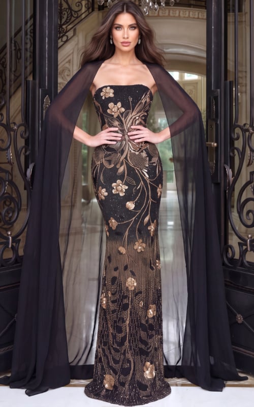 Full length black gown covered in copper sequin florals, sheer cape sweeping from the shoulders