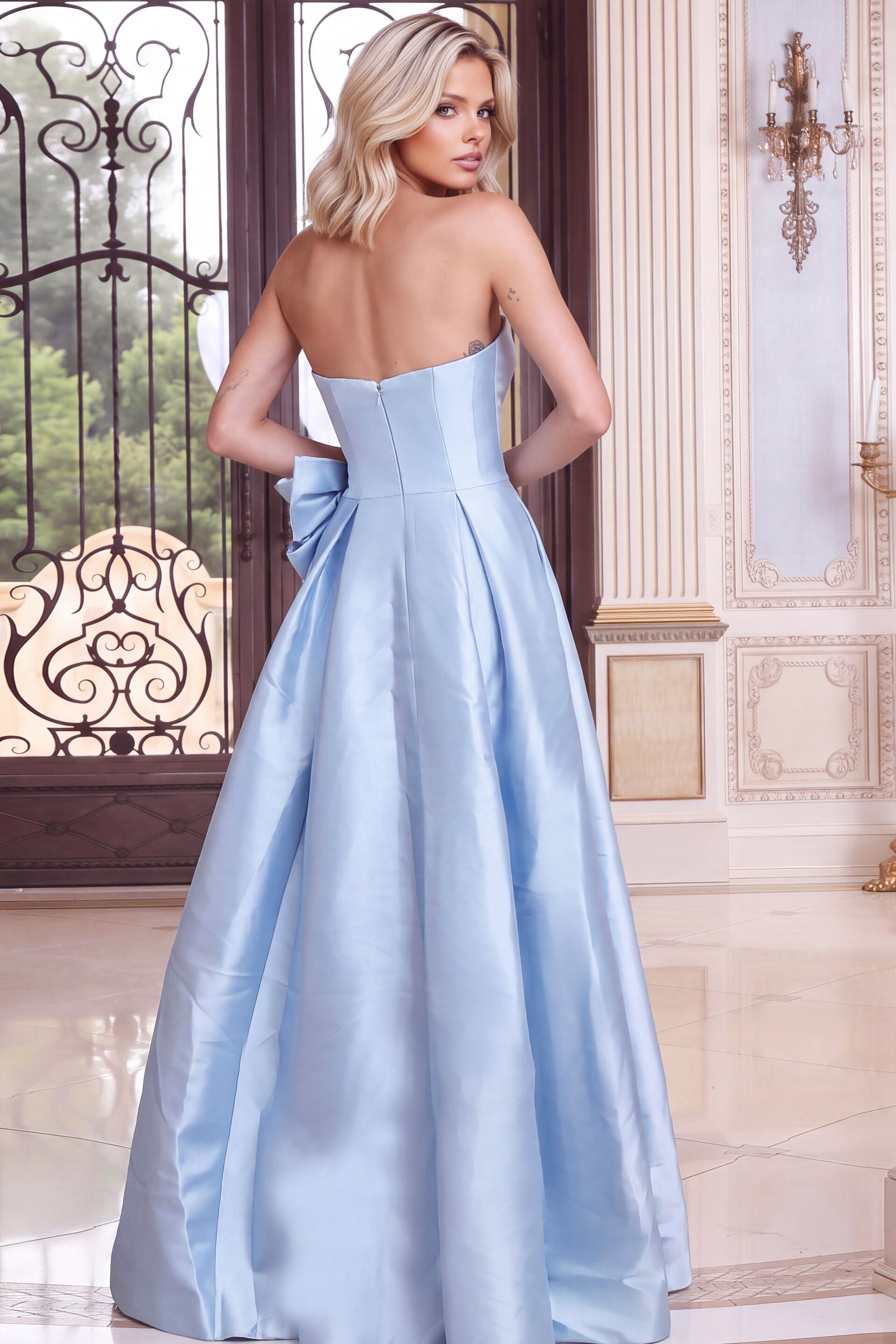 Seamed corset back, zipper and side bow on a light blue strapless gown, rear view