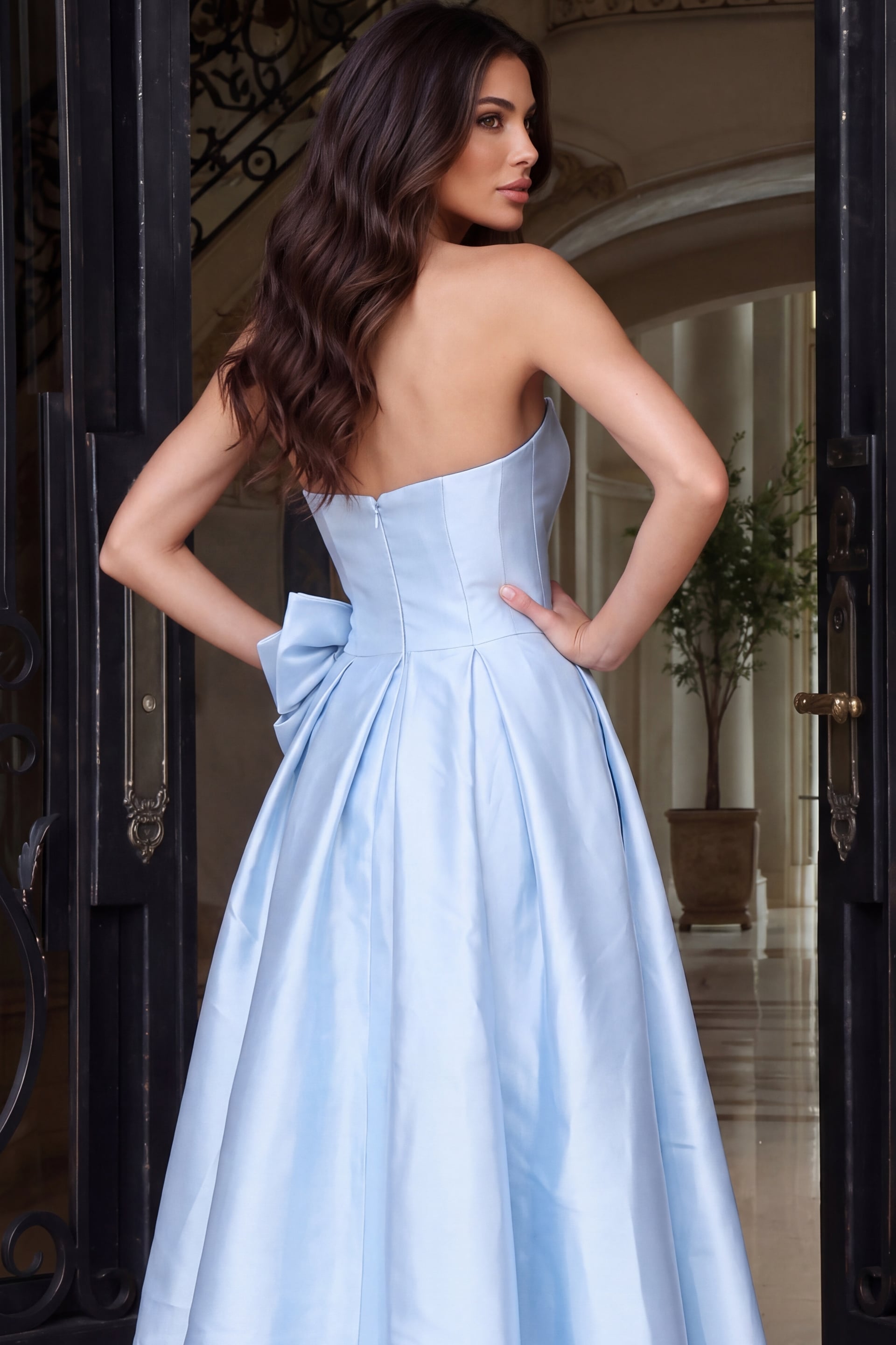 Cropped rear detail of a blue strapless bodice with seamed back and oversized waist bow