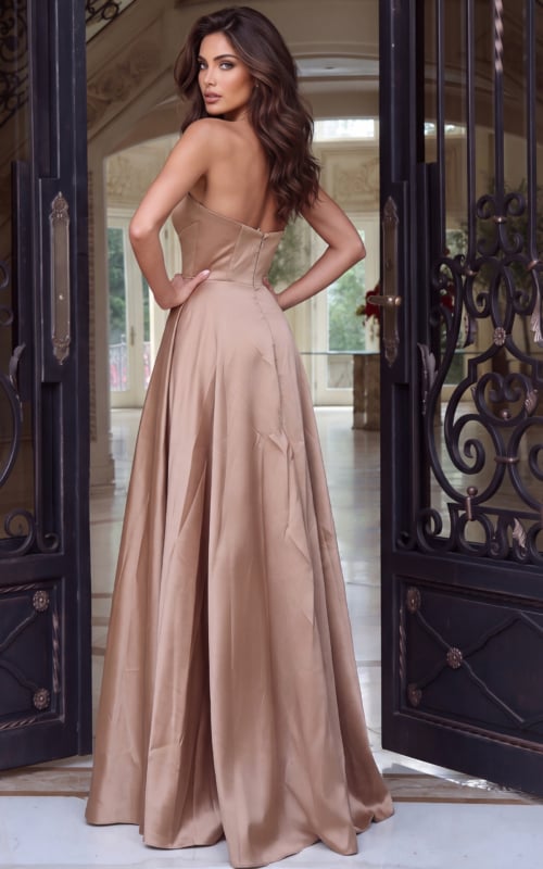 Seen from the rear, a mocha organza ball gown with bare back and sweeping skirt