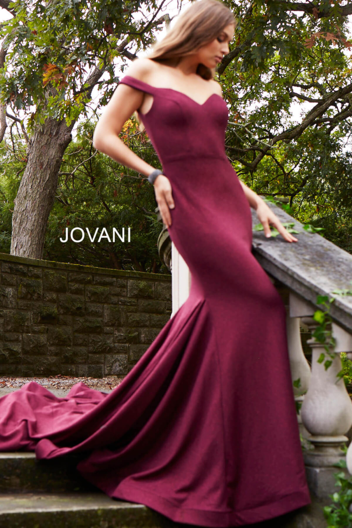 Model wearing Jovani 55187 burgundy dress front