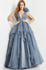Model in Jovani 55210 gray gown with layered ruffles and fitted waist.