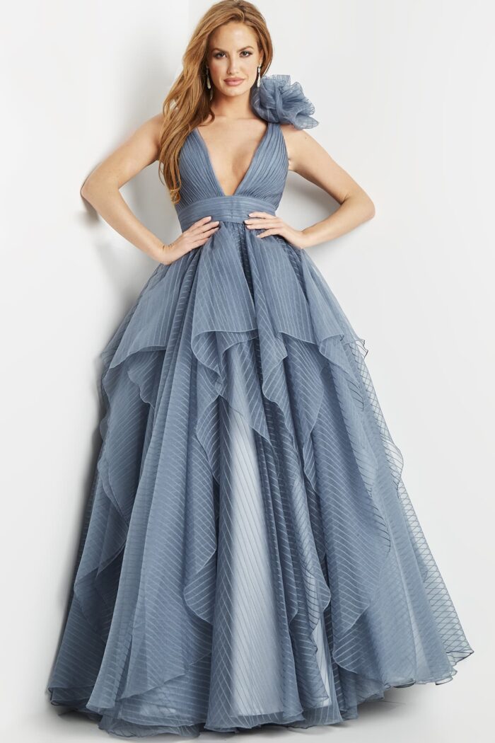 Model in Jovani 55210 gray gown with layered ruffles and fitted waist.