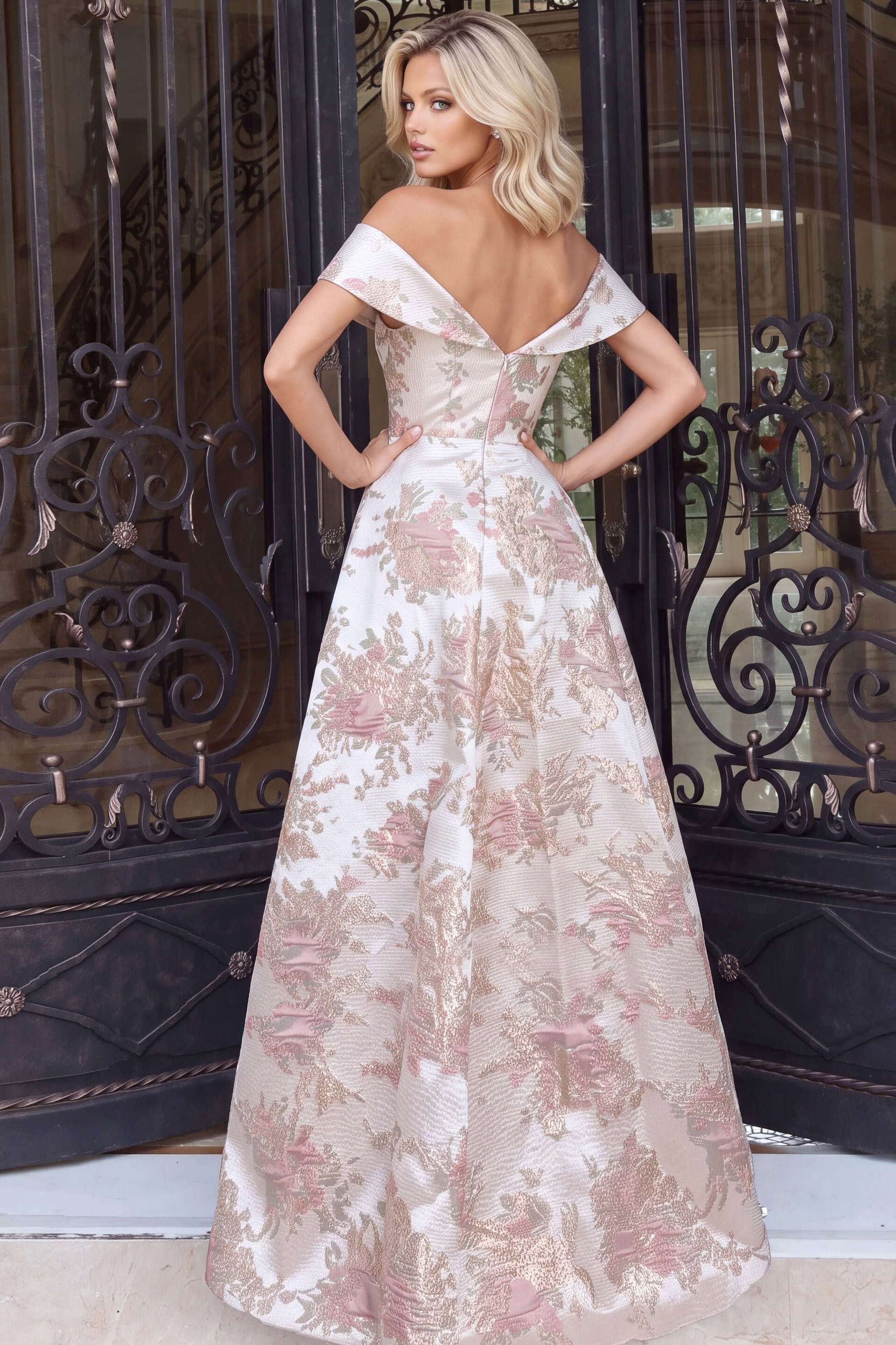 Wide pleated skirt and low V back on a champagne floral jacquard gown, rear view