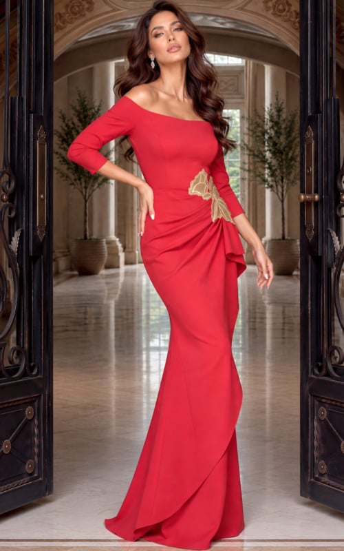 Angled shot of a red crepe gown with sleeves to the elbow and a gold appliqué waist detail