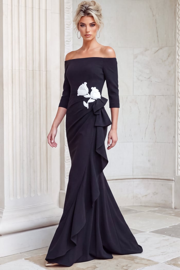 Black off shoulder gown with three quarter sleeves, floral appliqué and a cascading ruffle skirt