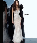 Model posing in Jovani 55796 ivory gown with V-neck and feathered details.