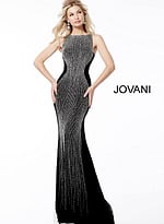 Model wearing Jovani 57935 black gown with striking bead pattern.