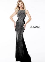 Model in Jovani 57935 full-length black gown with beaded design.