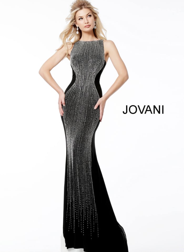 Model in Jovani 57935 full-length black gown with beaded design.