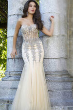 Model wearing Jovani 5908 beige mermaid gown with beaded details