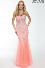 Model in Jovani 5908 coral tinted gown featured with beading.