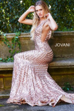 Model seated in a Jovani 59762 rosegold gown with sparkling sequin detailing.