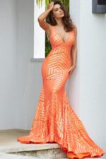 Model in Jovani 59762 orange gown with a fitted bodice and shimmering sequins.