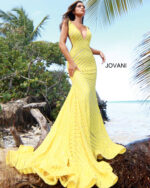 Model wearing Jovani 59762 yellow gown with a mesmerizing mermaid silhouette and sequins.