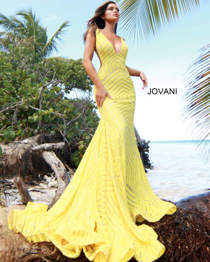 Model wearing Jovani 59762 yellow gown with a mesmerizing mermaid silhouette and sequins.