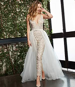 Model wearing Jovani 60010 nude gown with deep V-neckline and tulle overlay.