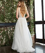 Rear view of Jovani 60010 nude gown with flowing tulle.