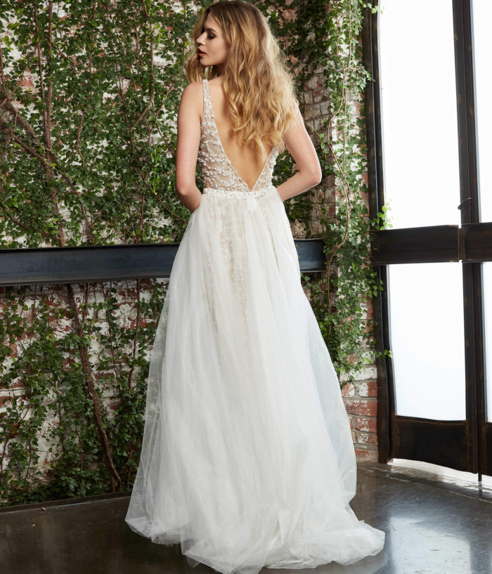 Rear view of Jovani 60010 nude gown with flowing tulle.