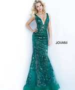 Model wearing Jovani 60283 mermaid gown in green with floral embroidery.