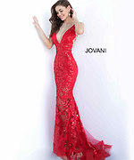 Model wearing Jovani 60283 mermaid gown in red with floral embroidery.
