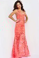 Model in Jovani 60283 tangerine gown with detailed floral lace.
