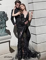 Model in Jovani 60283 black mermaid gown with plunging neckline.