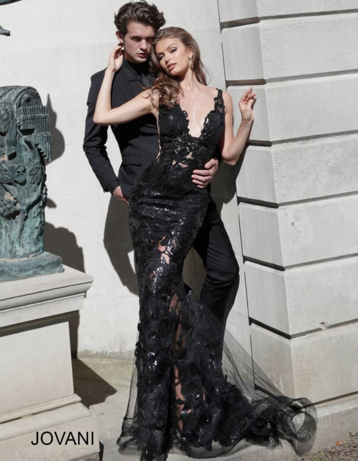 Model in Jovani 60283 black mermaid gown with plunging neckline.