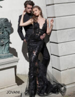 Model wearing Jovani 60283 in black, showing beaded lace detail.