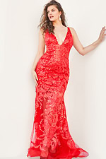 Model wearing Jovani 60283 mermaid gown in red with floral embroidery.