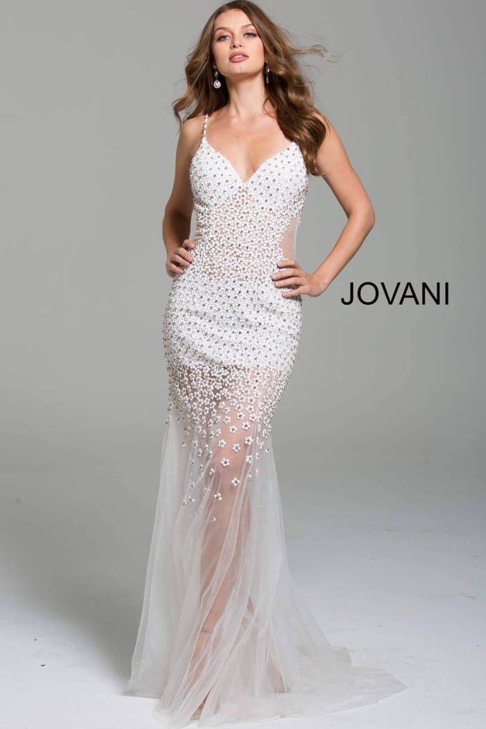 Model wearing Jovani 60695 gown in white, featuring a sheer skirt with floral applique, front view.
