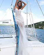 Jovani 60695 gown in white with a fitted silhouette and floral appliques, captured from the front.
