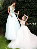 models wearing Jovani 61109 blue and blush gowns, posing together