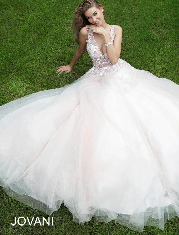 model wearing Jovani 61109 blush gown, sitting with a flowing skirt