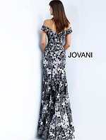 Model wearing Jovani 61380 black dress with off-shoulder neckline and floral embroidery, full front view.