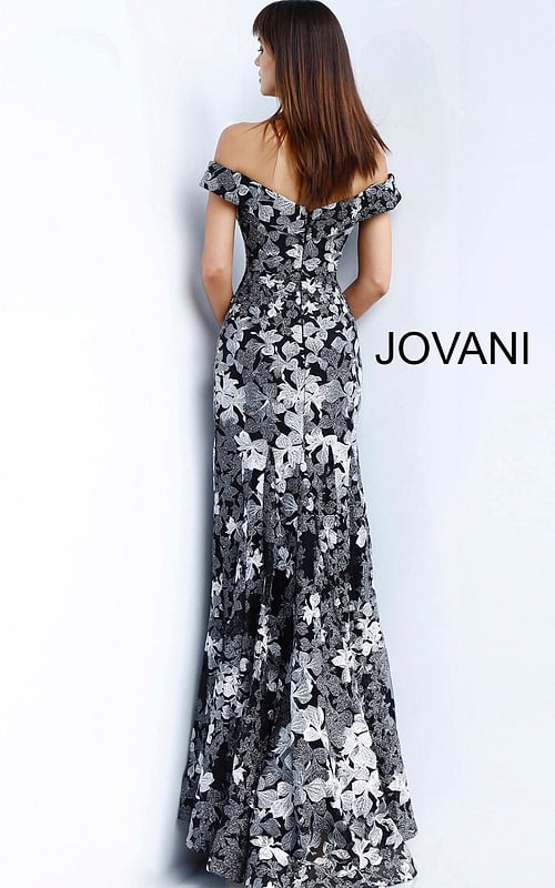 Model wearing Jovani 61380 black dress with off-shoulder neckline and floral embroidery, full front view.
