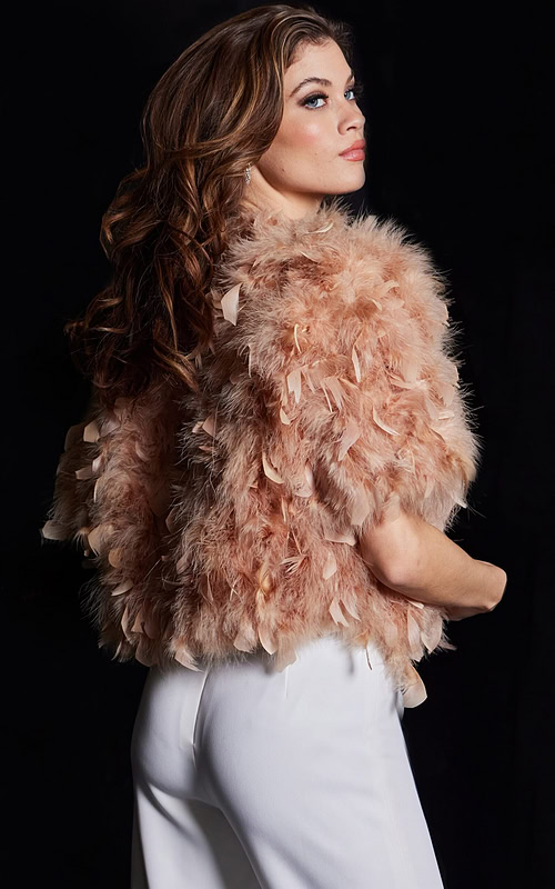 Model in Jovani 62104 nude dress, back view highlighting feather details.